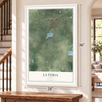 La Feria, Texas map, 24 x 36 inch print in a white frame by a staircase