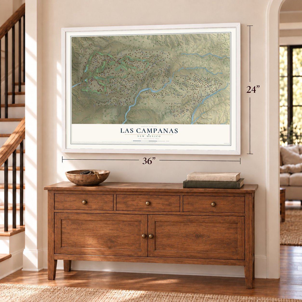 Las Campanas, New Mexico map, 24 x 36 inch print in a white frame above a dresser by a staircase