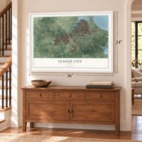 League City, Texas map, 24 x 36 inch print in a white frame above a dresser by a staircase
