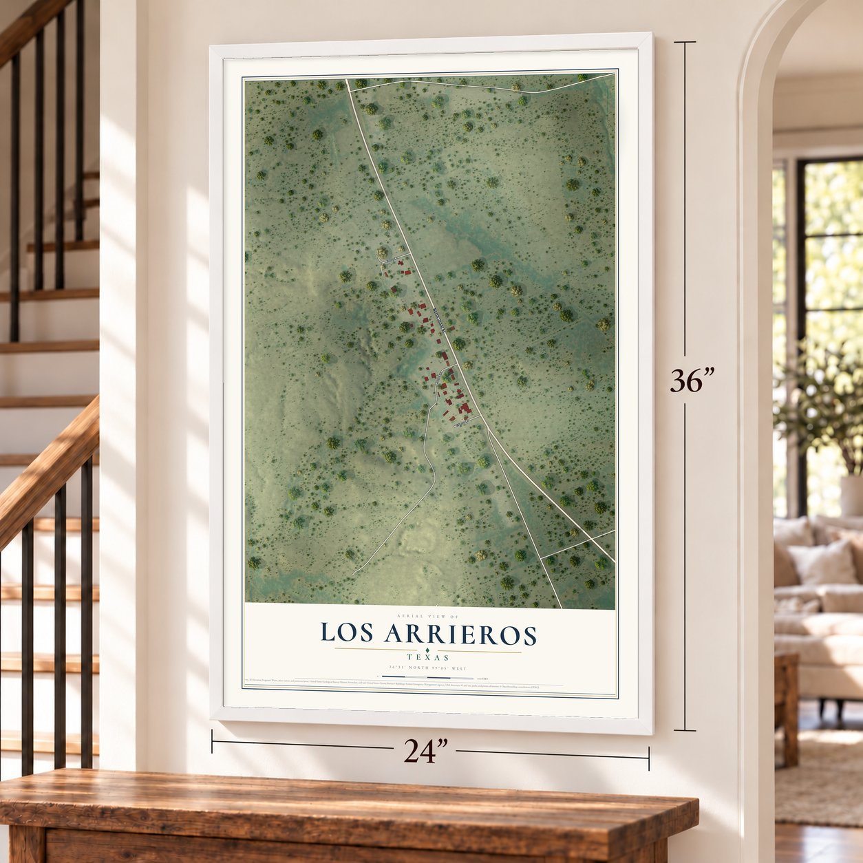 Los Arrieros, Texas map, 24 x 36 inch print in a white frame by a staircase
