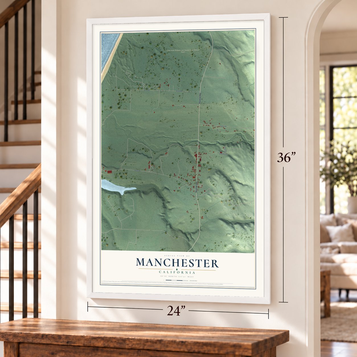Manchester, California map, 24 x 36 inch print in a white frame by a staircase