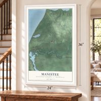Manistee, Manistee County, Michigan map, 24 x 36 inch print in a white frame by a staircase