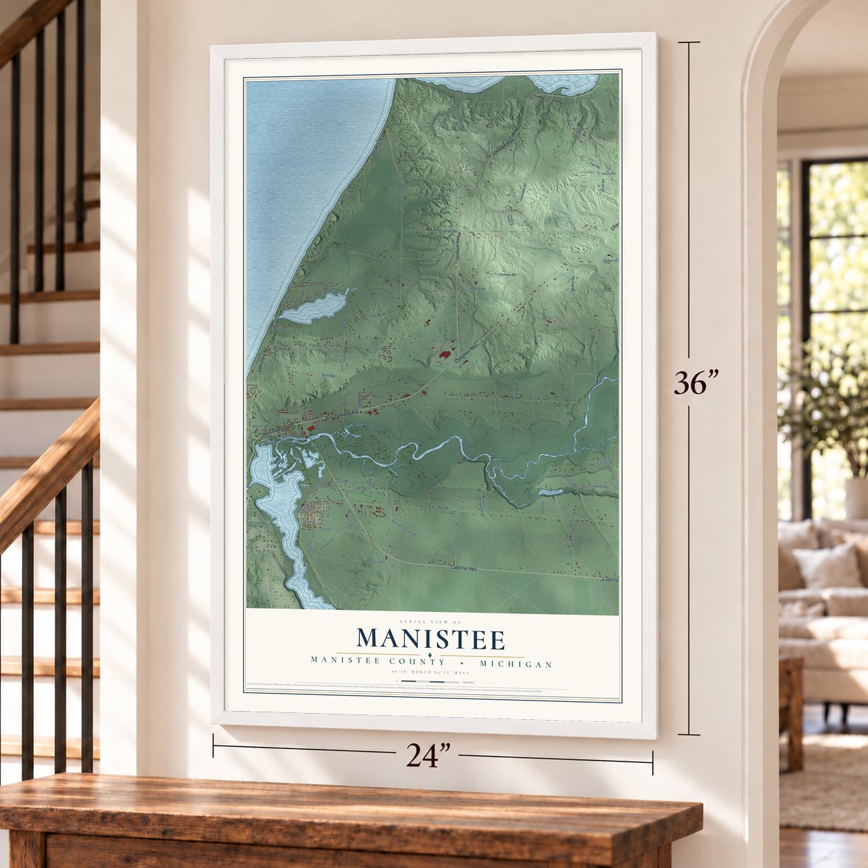 Manistee, Manistee County, Michigan map, 24 x 36 inch print in a white frame by a staircase