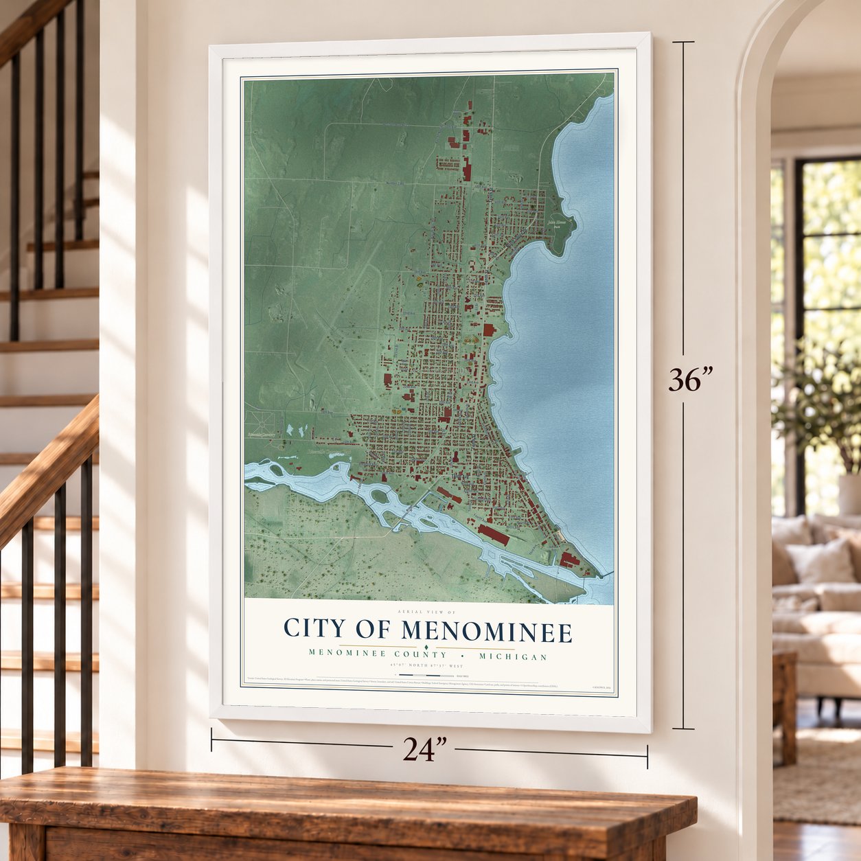Menominee, Michigan map, 24 x 36 inch print in a white frame by a staircase