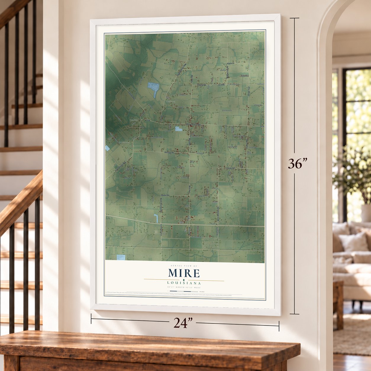 Mire, Louisiana map, 24 x 36 inch print in a white frame by a staircase