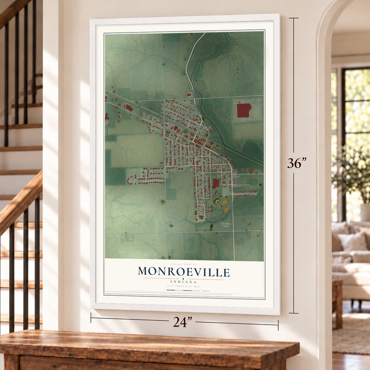 Monroeville, Indiana map, 24 x 36 inch print in a white frame by a staircase