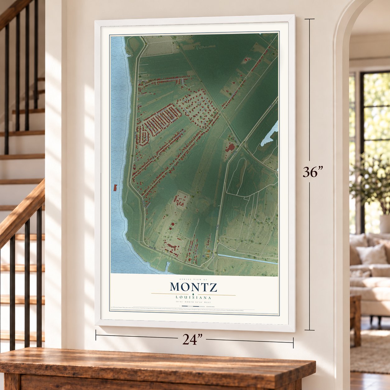 Montz, Louisiana map, 24 x 36 inch print in a white frame by a staircase