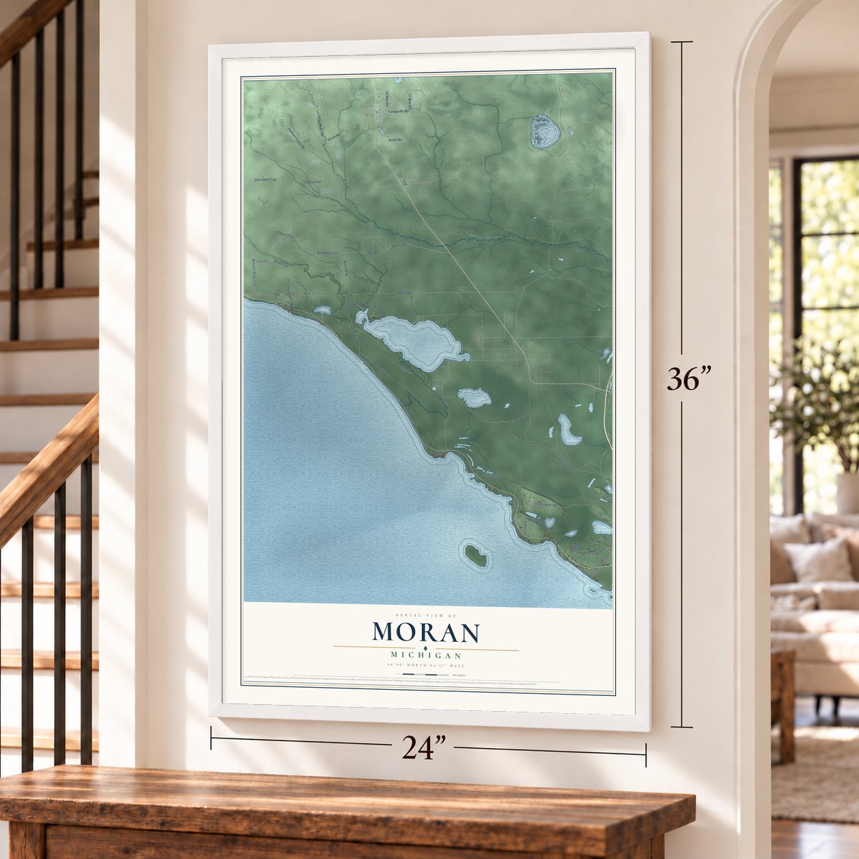 Moran, Michigan map, 24 x 36 inch print in a white frame by a staircase