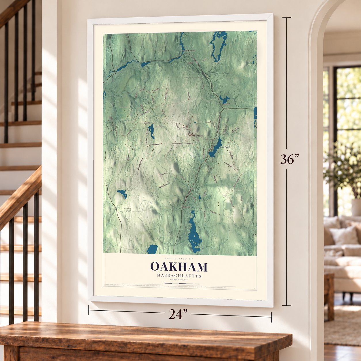 Oakham, Massachusetts map, 24 x 36 inch print in a white frame by a staircase