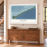 Ocracoke, North Carolina map, 24 x 36 inch print in a white frame above a dresser by a staircase