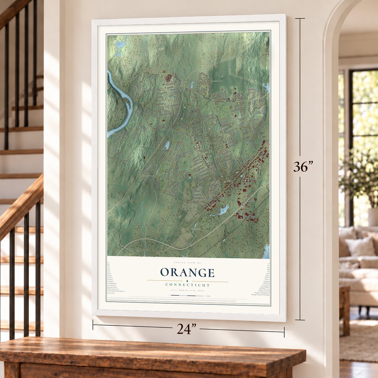 Orange, Connecticut map, 24 x 36 inch print in a white frame by a staircase