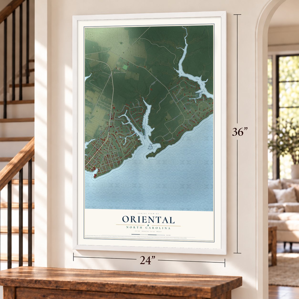 Oriental, North Carolina map, 24 x 36 inch print in a white frame by a staircase