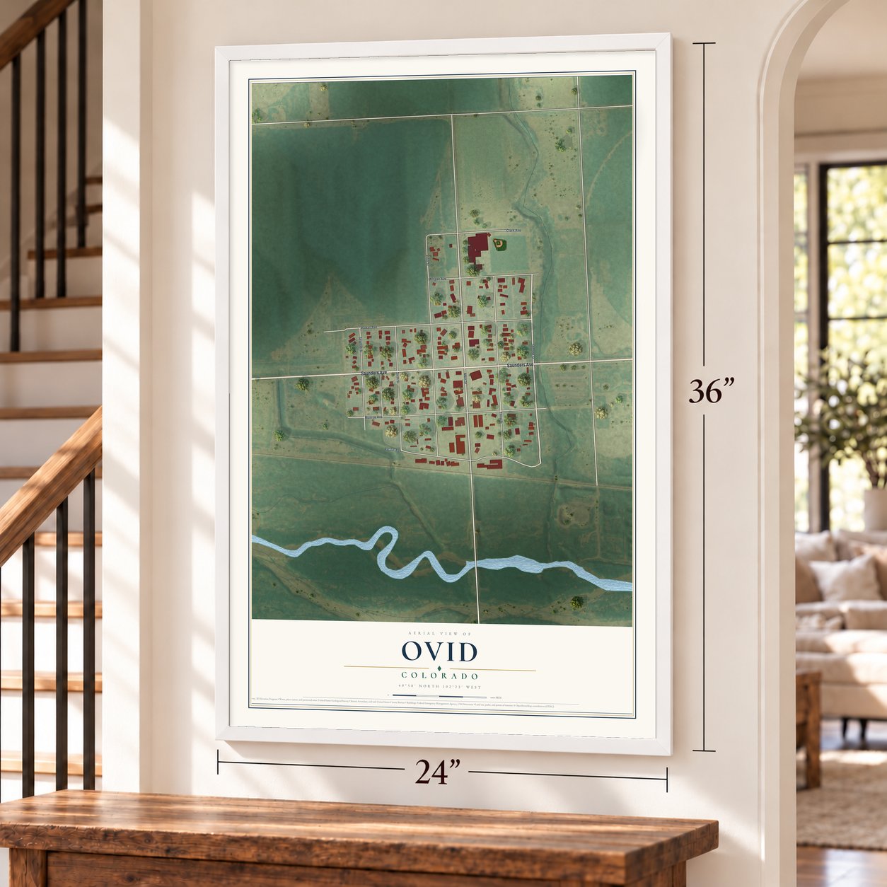 Ovid, Colorado map, 24 x 36 inch print in a white frame by a staircase