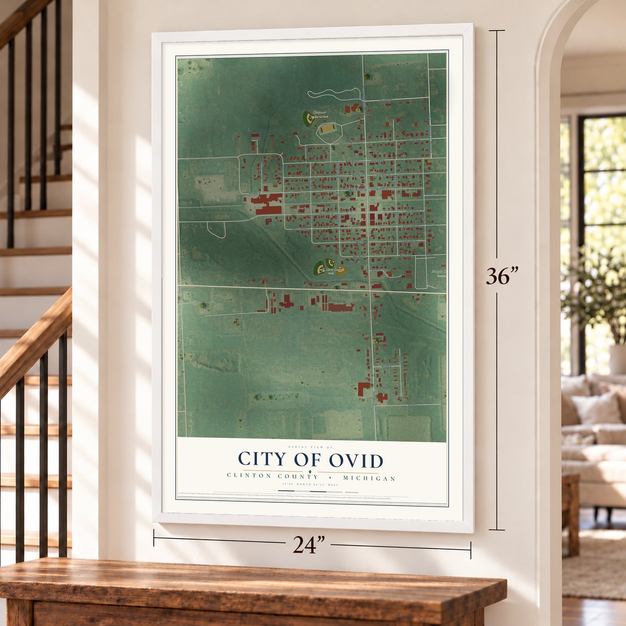 Ovid, Michigan map, 24 x 36 inch print in a white frame by a staircase