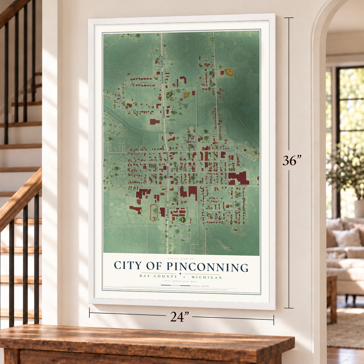 Pinconning, Michigan map, 24 x 36 inch print in a white frame by a staircase