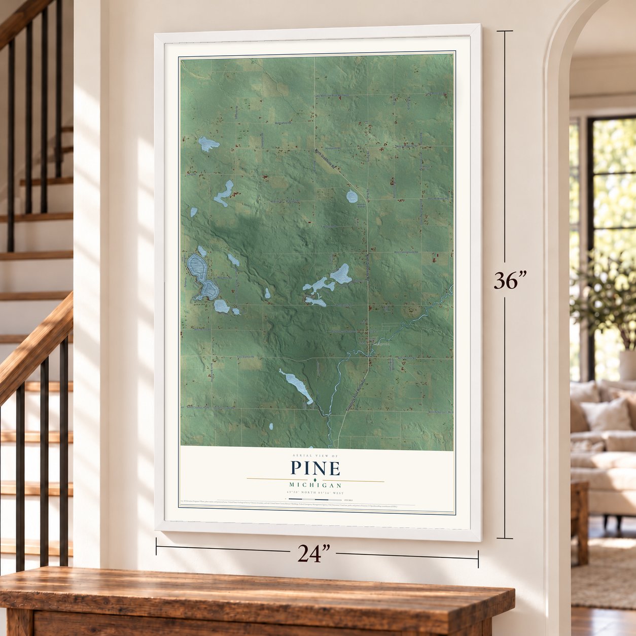 Pine, Michigan map, 24 x 36 inch print in a white frame by a staircase