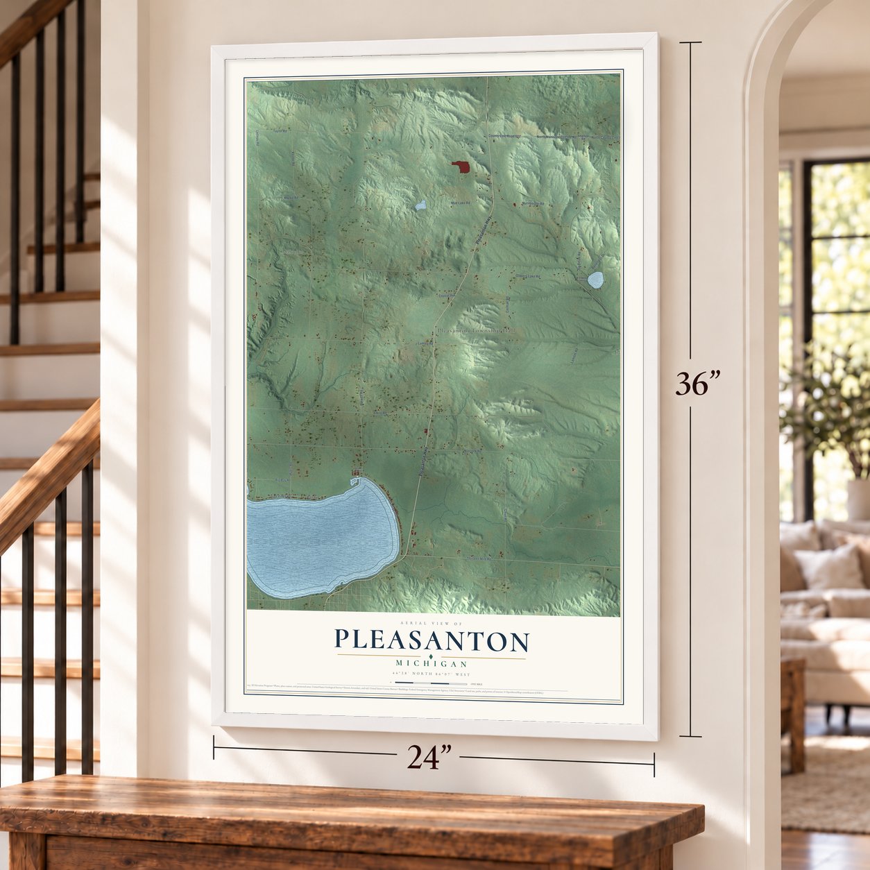 Pleasanton, Michigan map, 24 x 36 inch print in a white frame by a staircase