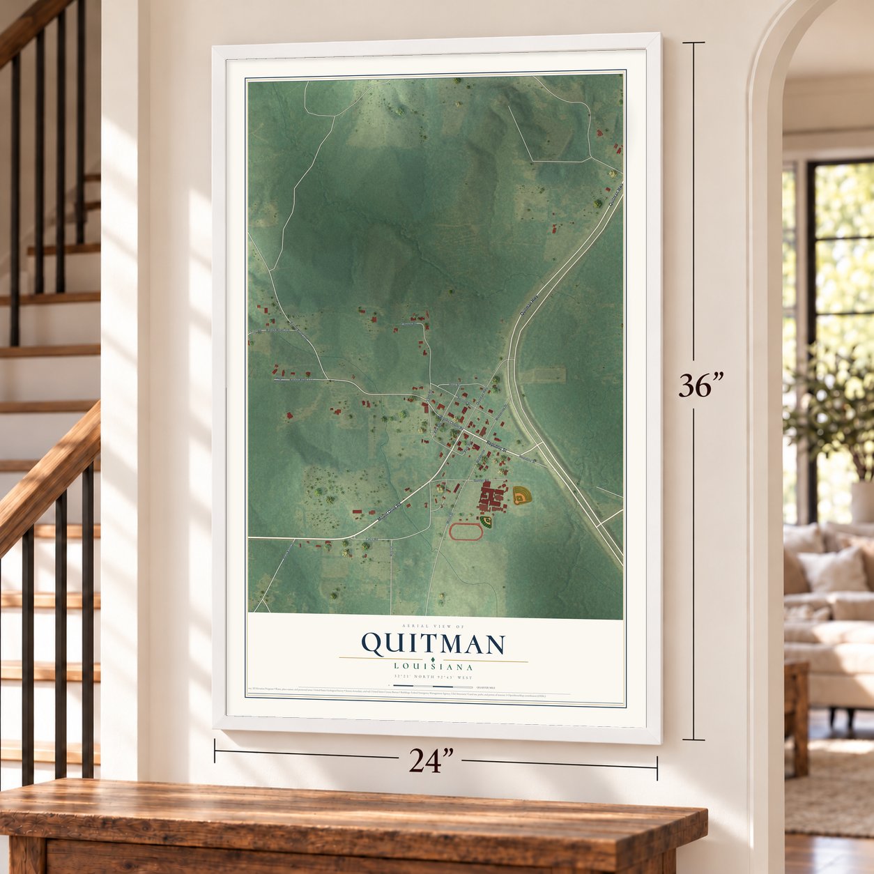 Quitman, Louisiana map, 24 x 36 inch print in a white frame by a staircase