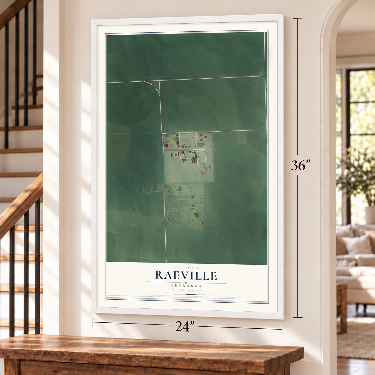 Raeville, Nebraska map, 24 x 36 inch print in a white frame by a staircase