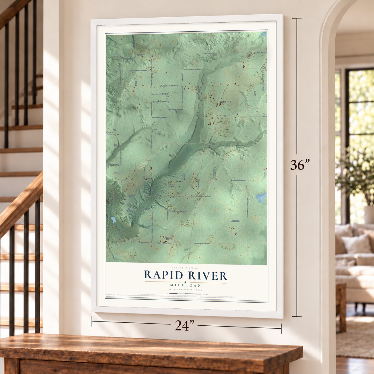 Rapid River, Michigan map, 24 x 36 inch print in a white frame by a staircase