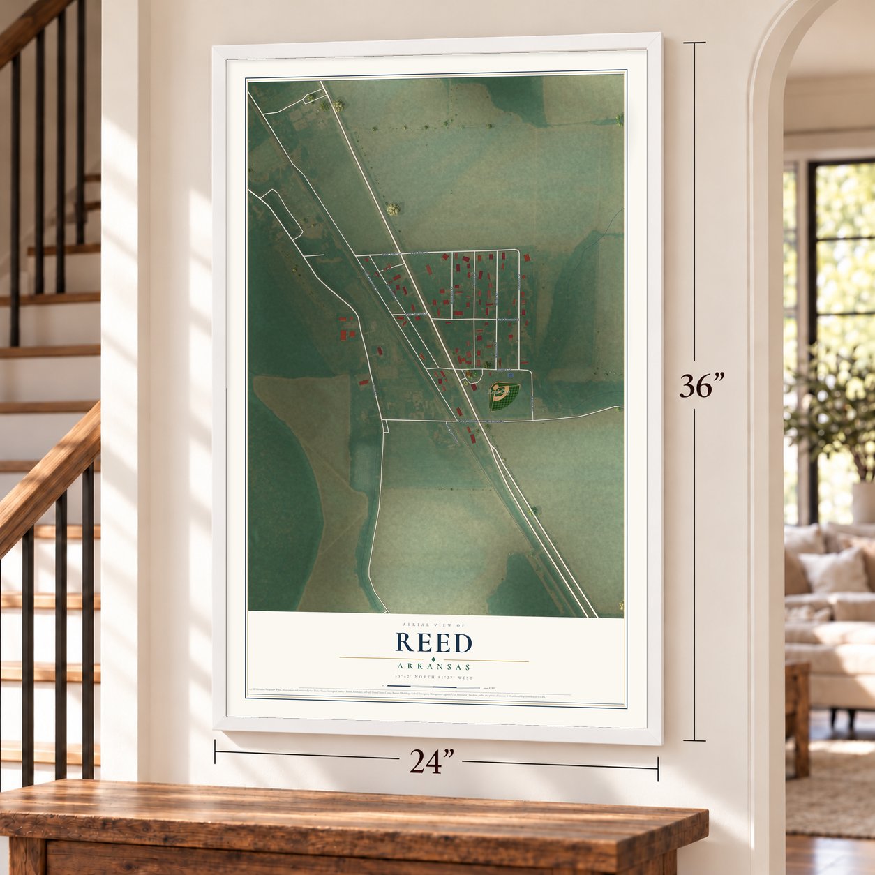Reed, Arkansas map, 24 x 36 inch print in a white frame by a staircase