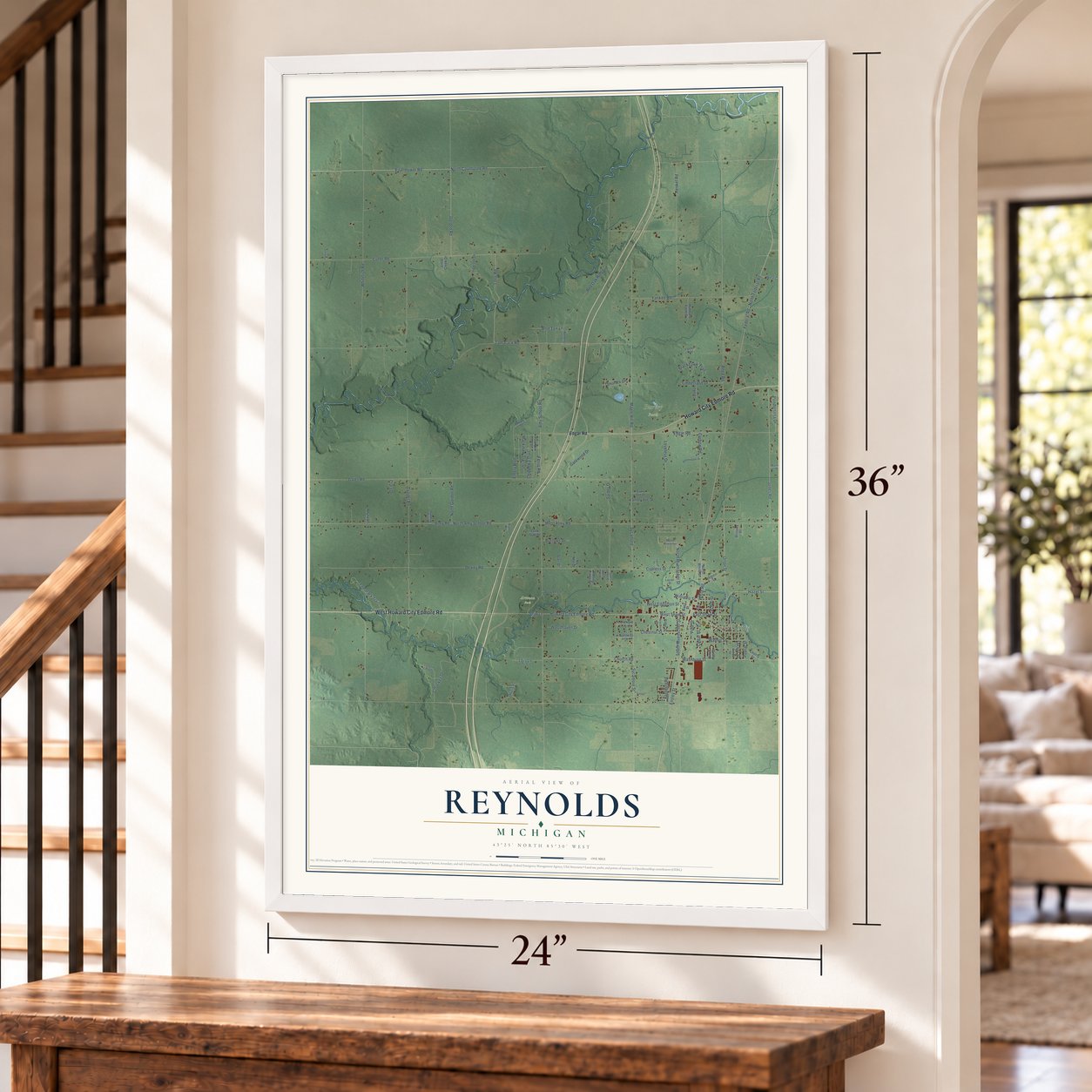 Reynolds, Michigan map, 24 x 36 inch print in a white frame by a staircase