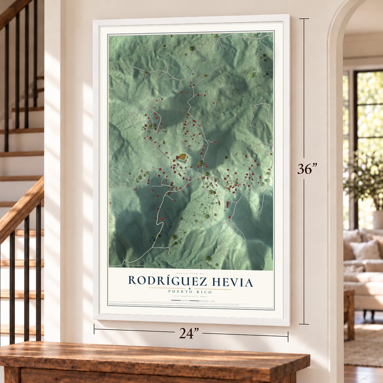 Rodríguez Hevia, Puerto Rico map, 24 x 36 inch print in a white frame by a staircase