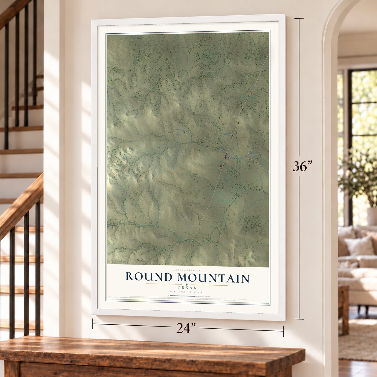 Round Mountain, Texas map, 24 x 36 inch print in a white frame by a staircase