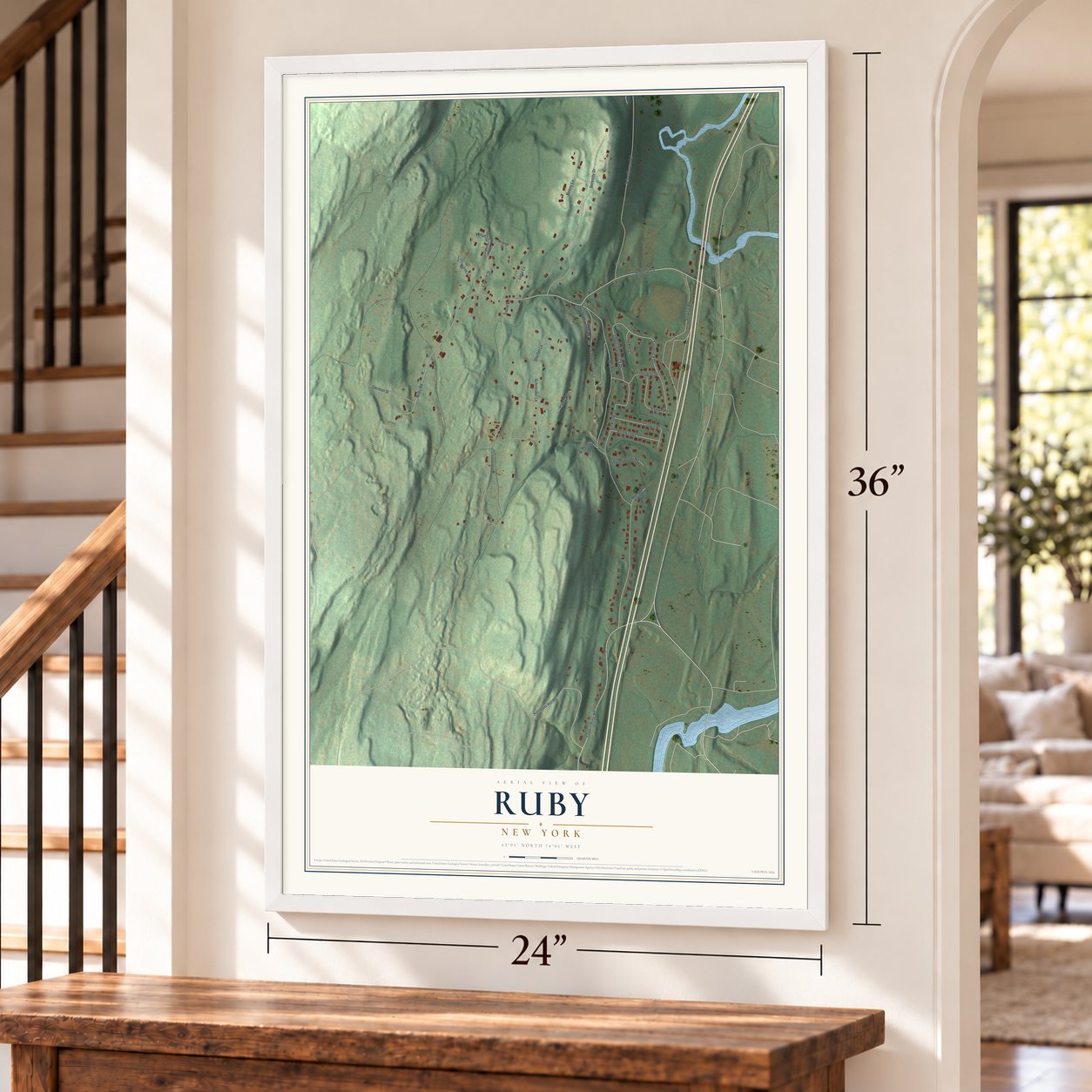Ruby, New York map, 24 x 36 inch print in a white frame by a staircase