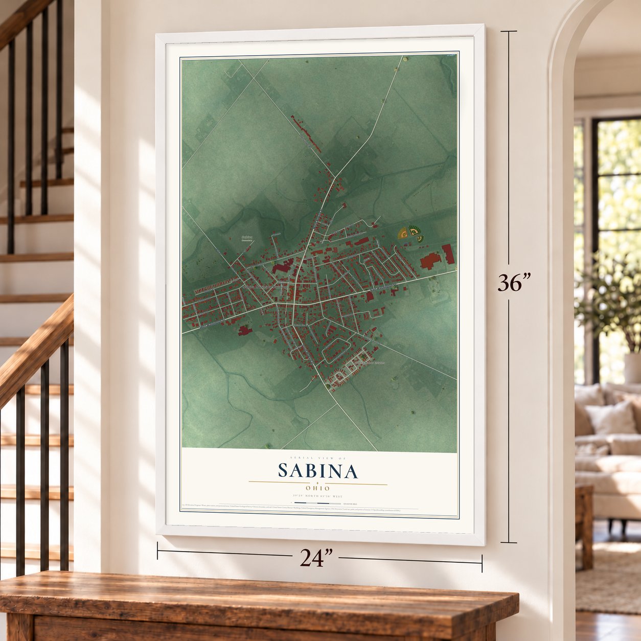 Sabina, Ohio map, 24 x 36 inch print in a white frame by a staircase