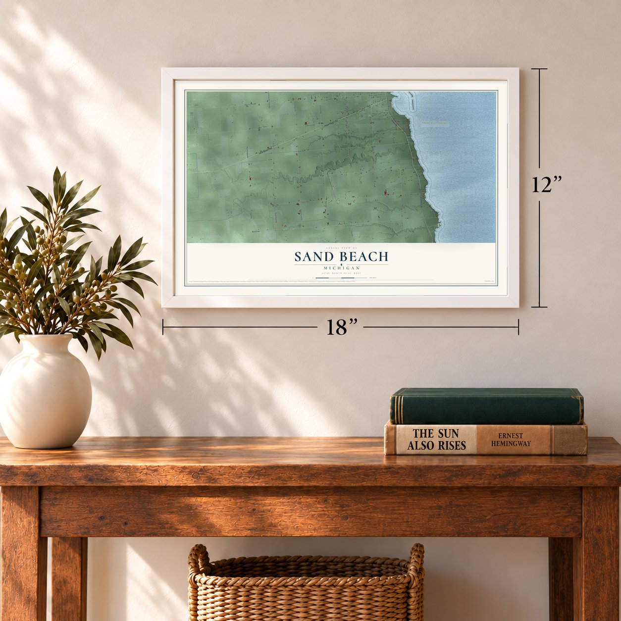 Sand Beach, Michigan map, 12 x 18 inch print in a white frame in an entryway