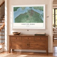 Sault Ste. Marie, Michigan map, 24 x 36 inch print in a white frame above a dresser by a staircase