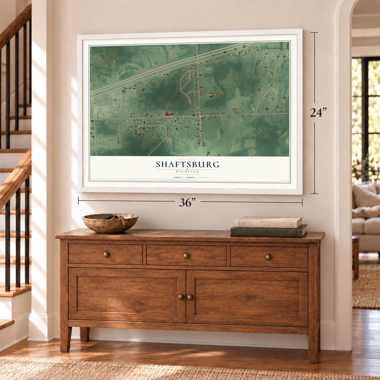 Shaftsburg, Michigan map, 24 x 36 inch print in a white frame above a dresser by a staircase