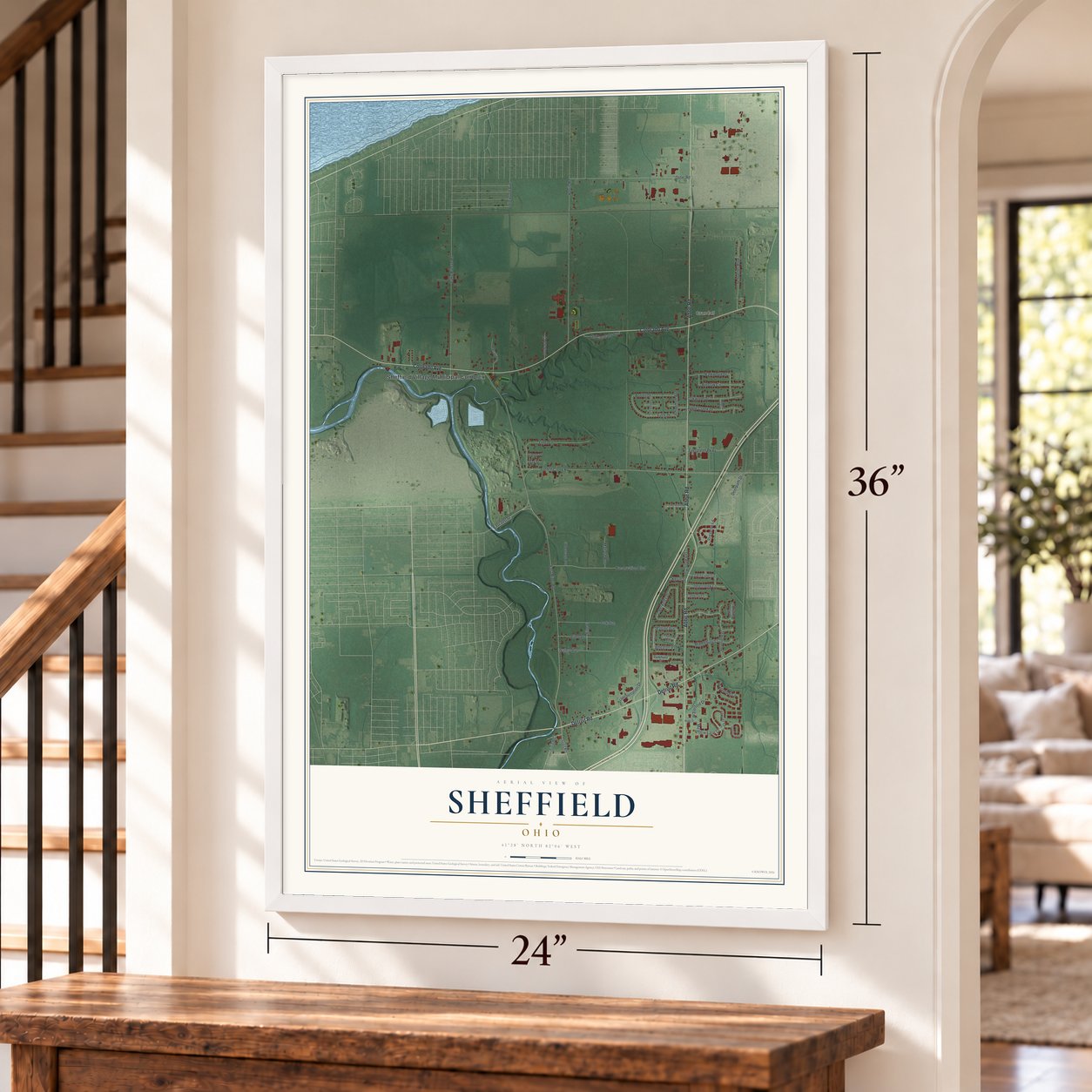 Sheffield, Ohio map, 24 x 36 inch print in a white frame by a staircase