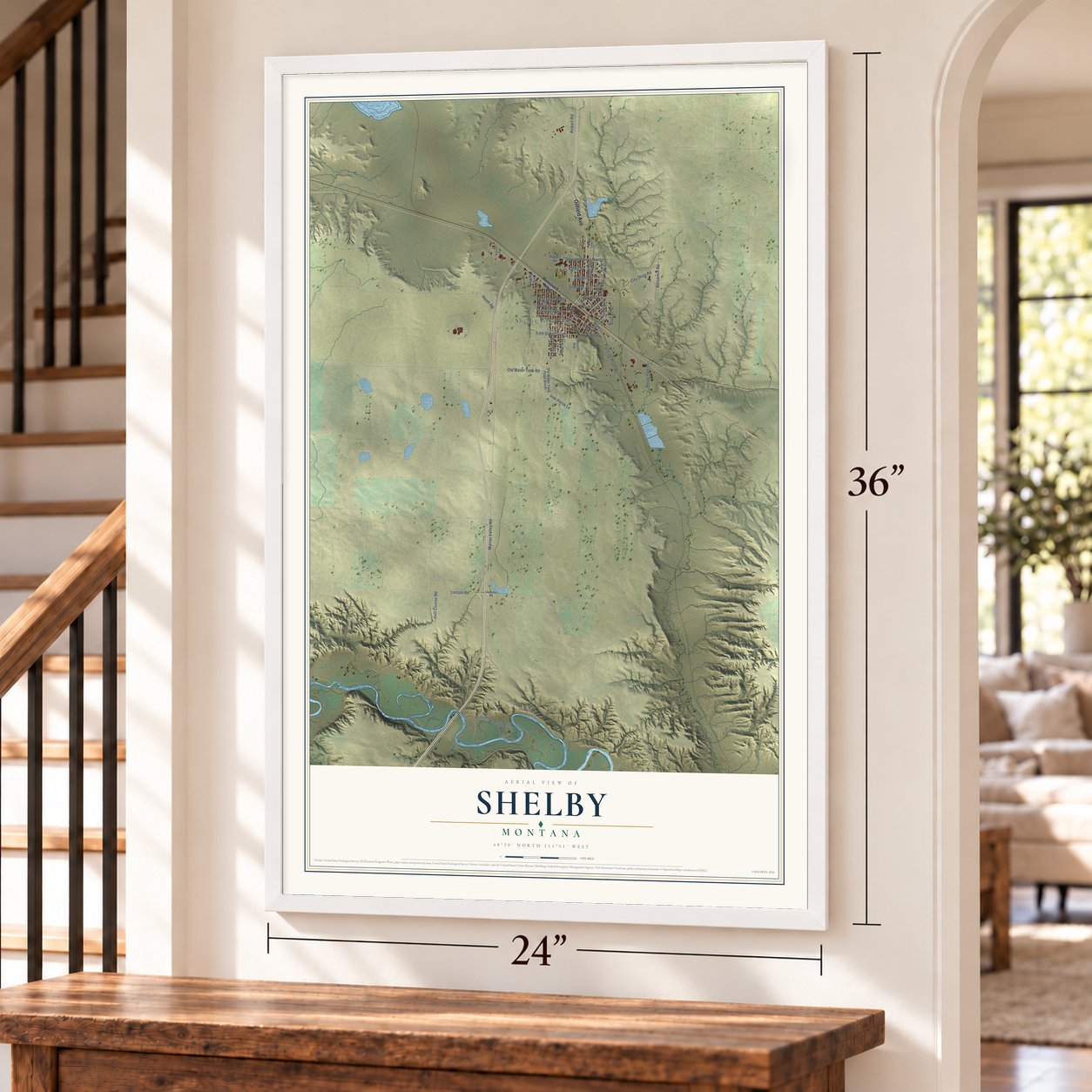 Shelby, Montana map, 24 x 36 inch print in a white frame by a staircase