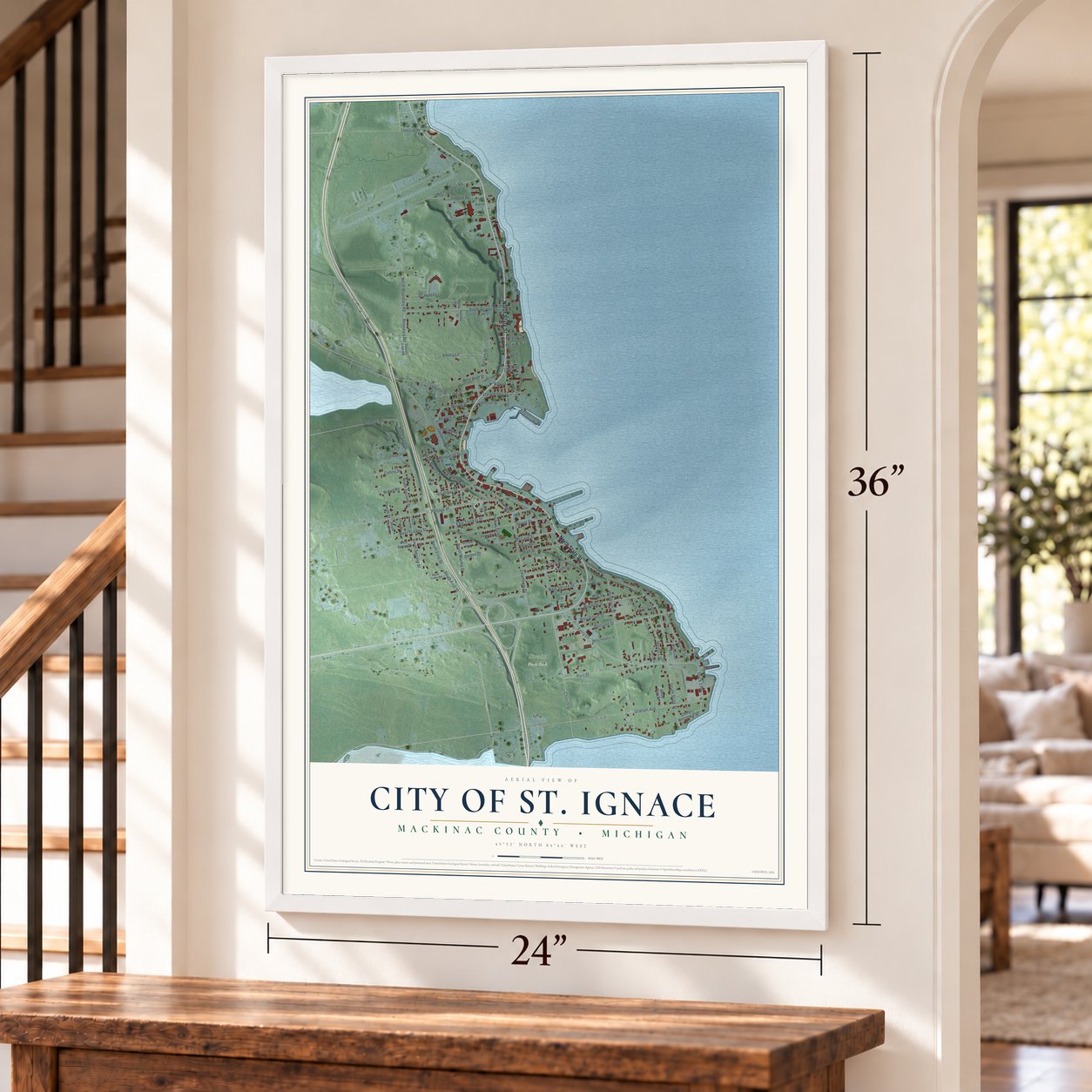 St. Ignace, Michigan map, 24 x 36 inch print in a white frame by a staircase