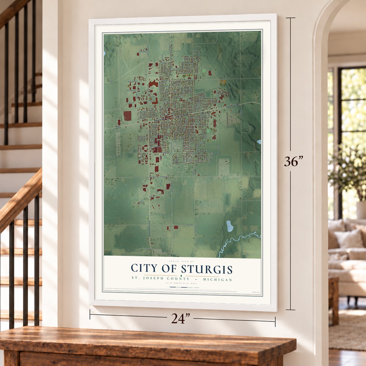 Sturgis, Michigan map, 24 x 36 inch print in a white frame by a staircase