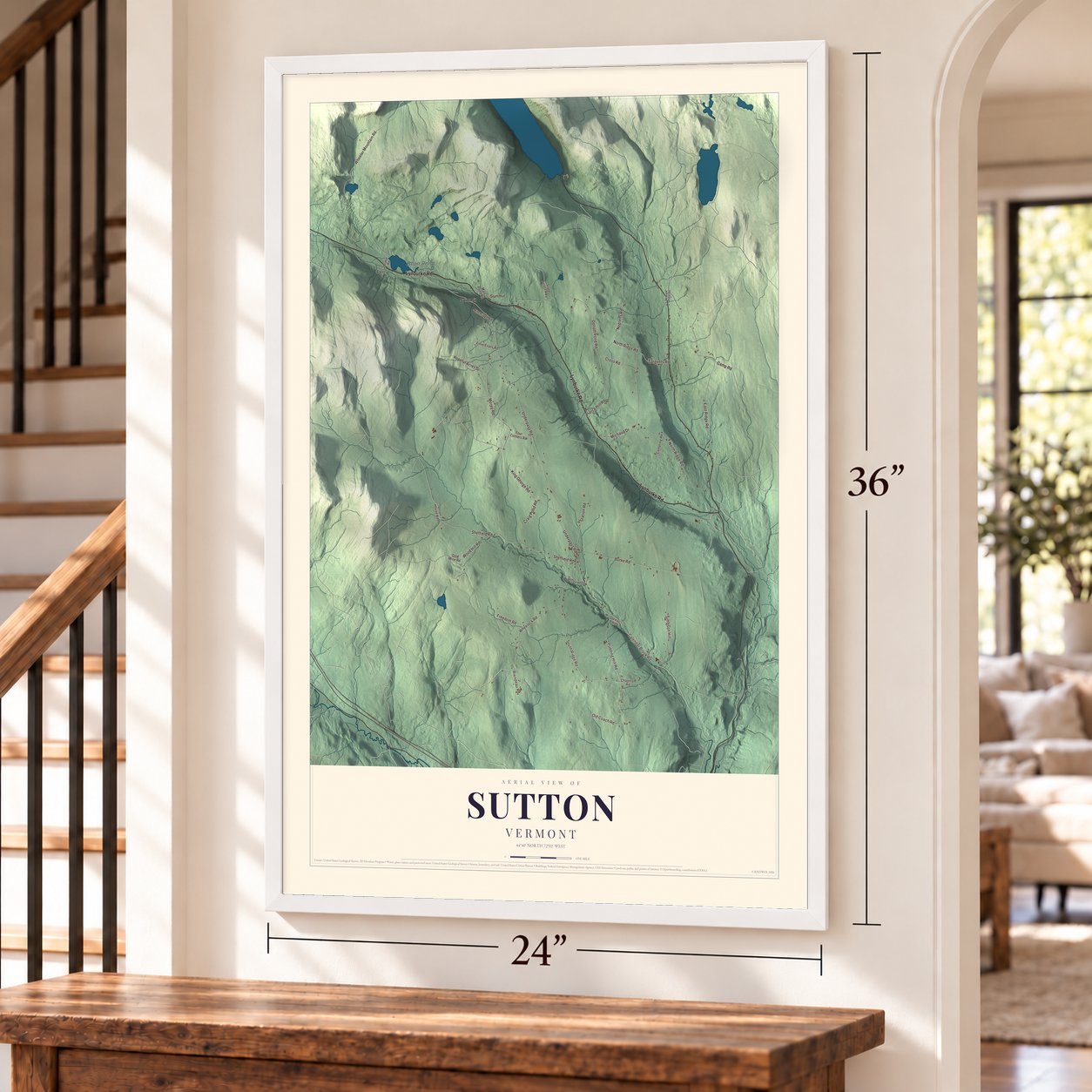 Sutton, Vermont map, 24 x 36 inch print in a white frame by a staircase
