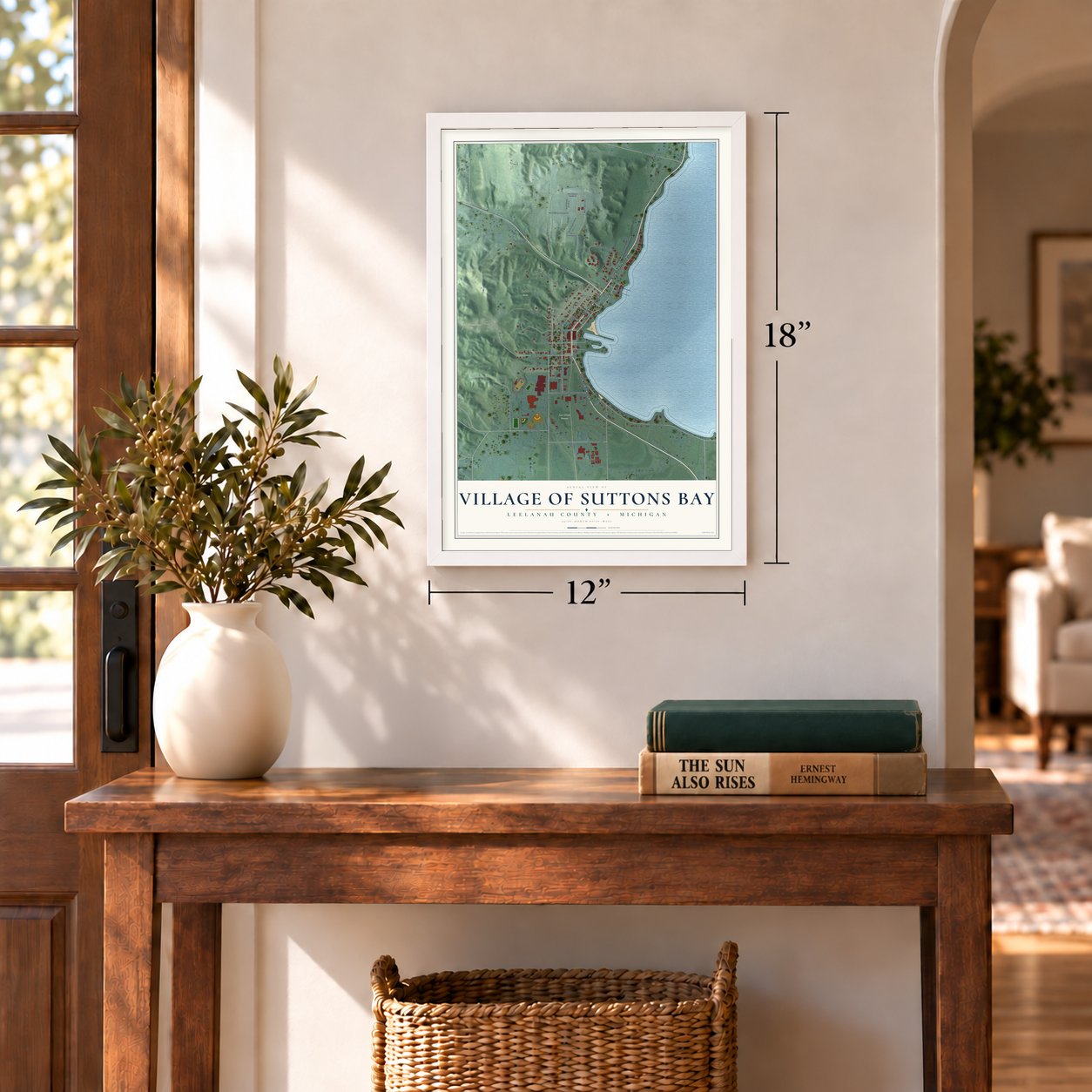 Suttons Bay, Michigan map, 12 x 18 inch print in a white frame in an entryway