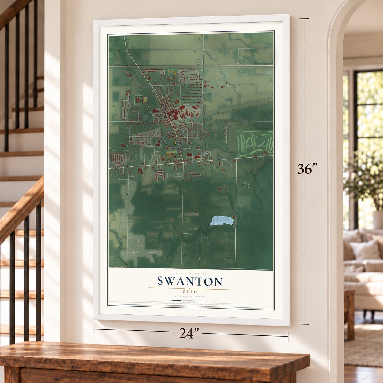 Swanton, Ohio map, 24 x 36 inch print in a white frame by a staircase