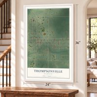 Thompsonville, Michigan map, 24 x 36 inch print in a white frame by a staircase