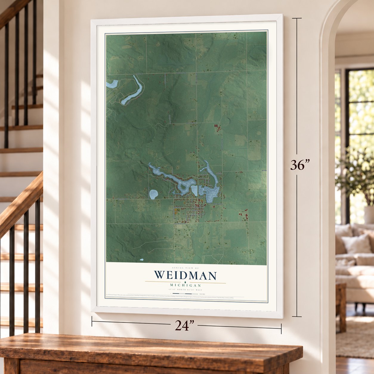 Weidman, Michigan map, 24 x 36 inch print in a white frame by a staircase
