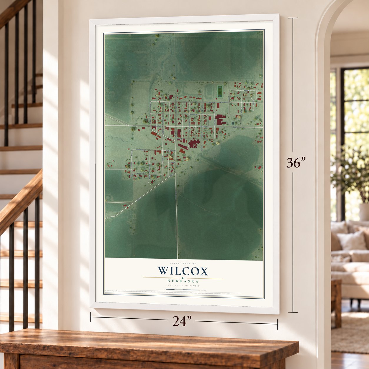 Wilcox, Nebraska map, 24 x 36 inch print in a white frame by a staircase
