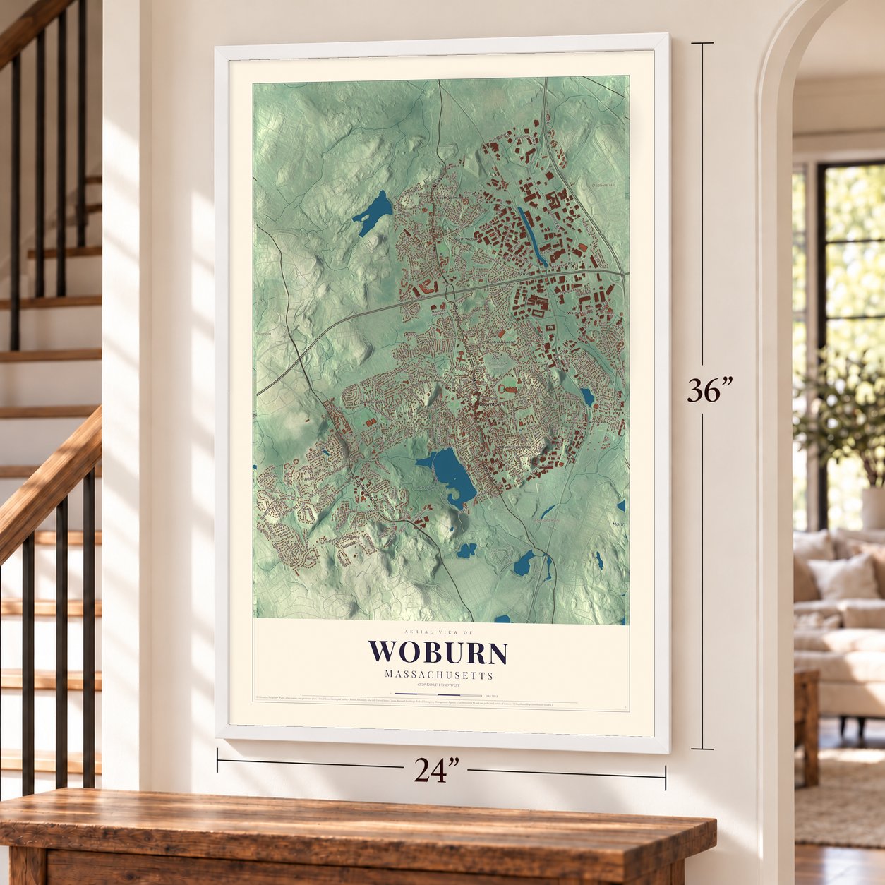 Woburn, Massachusetts map, 24 x 36 inch print in a white frame by a staircase