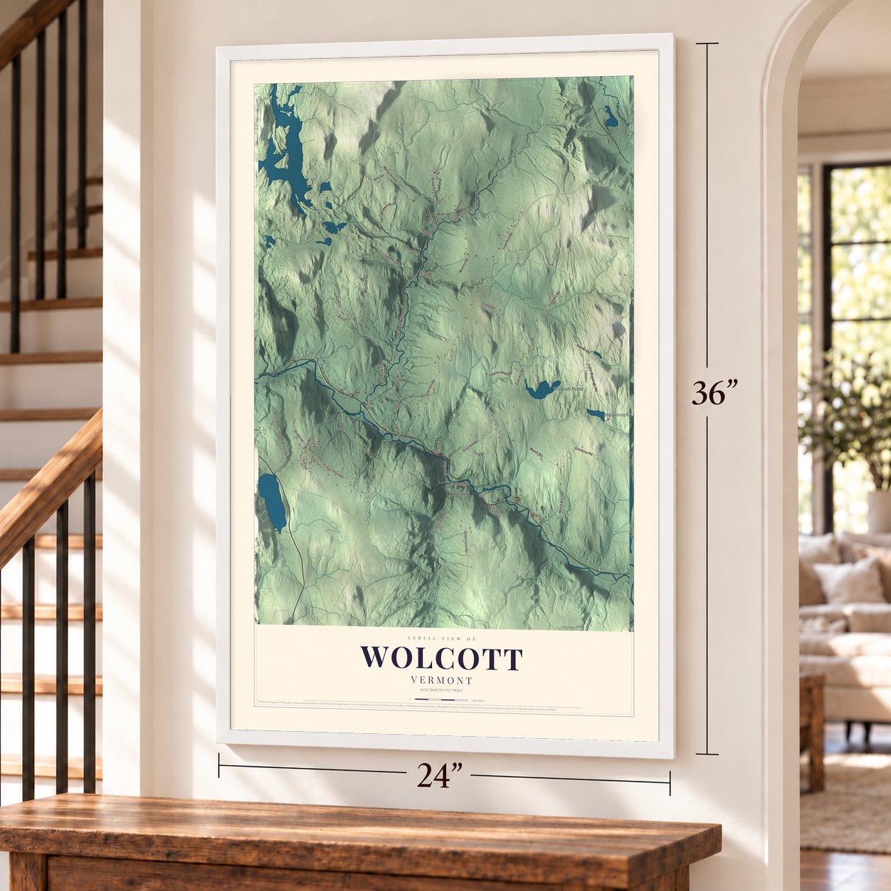 Wolcott, Vermont map, 24 x 36 inch print in a white frame by a staircase