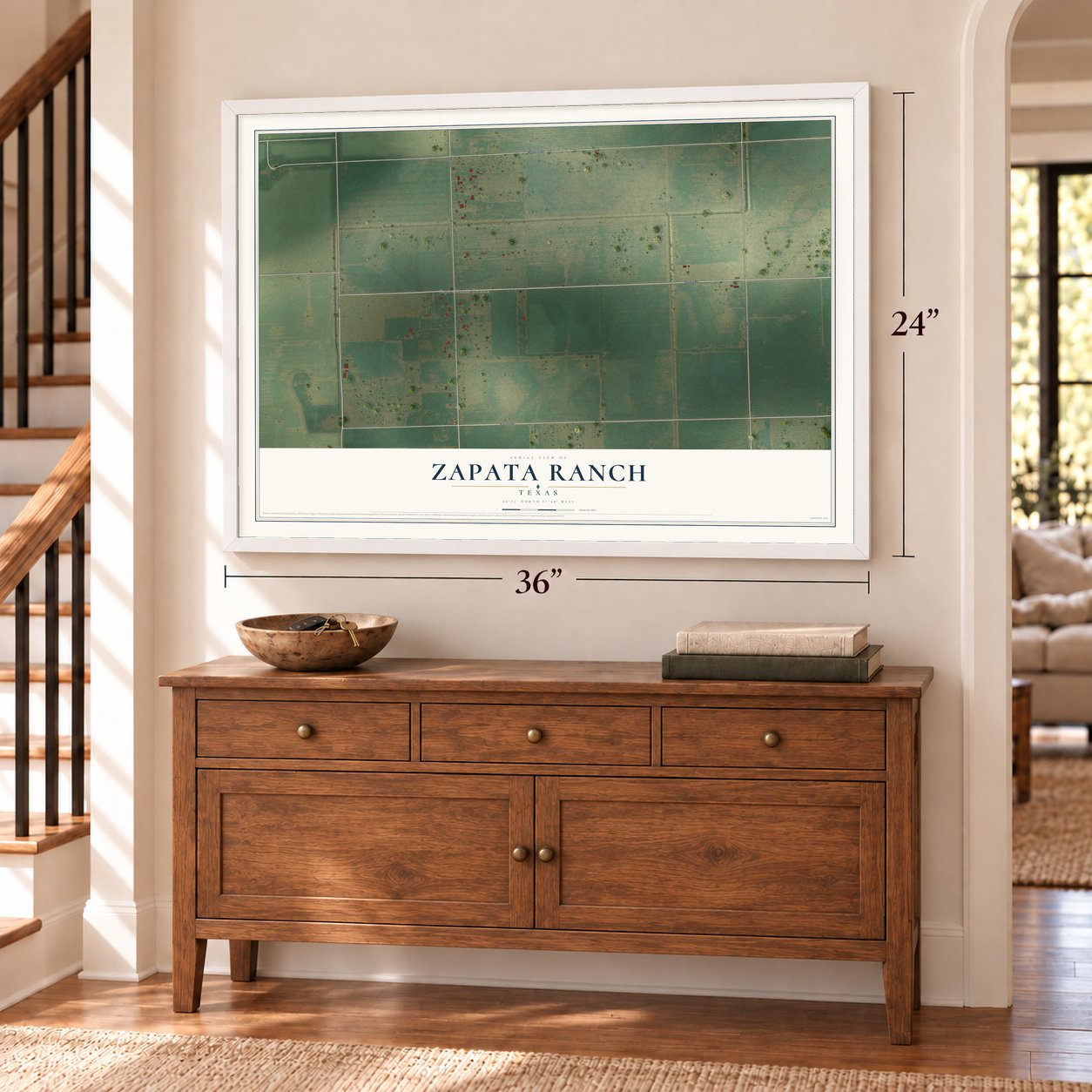 Zapata Ranch, Texas map, 24 x 36 inch print in a white frame above a dresser by a staircase