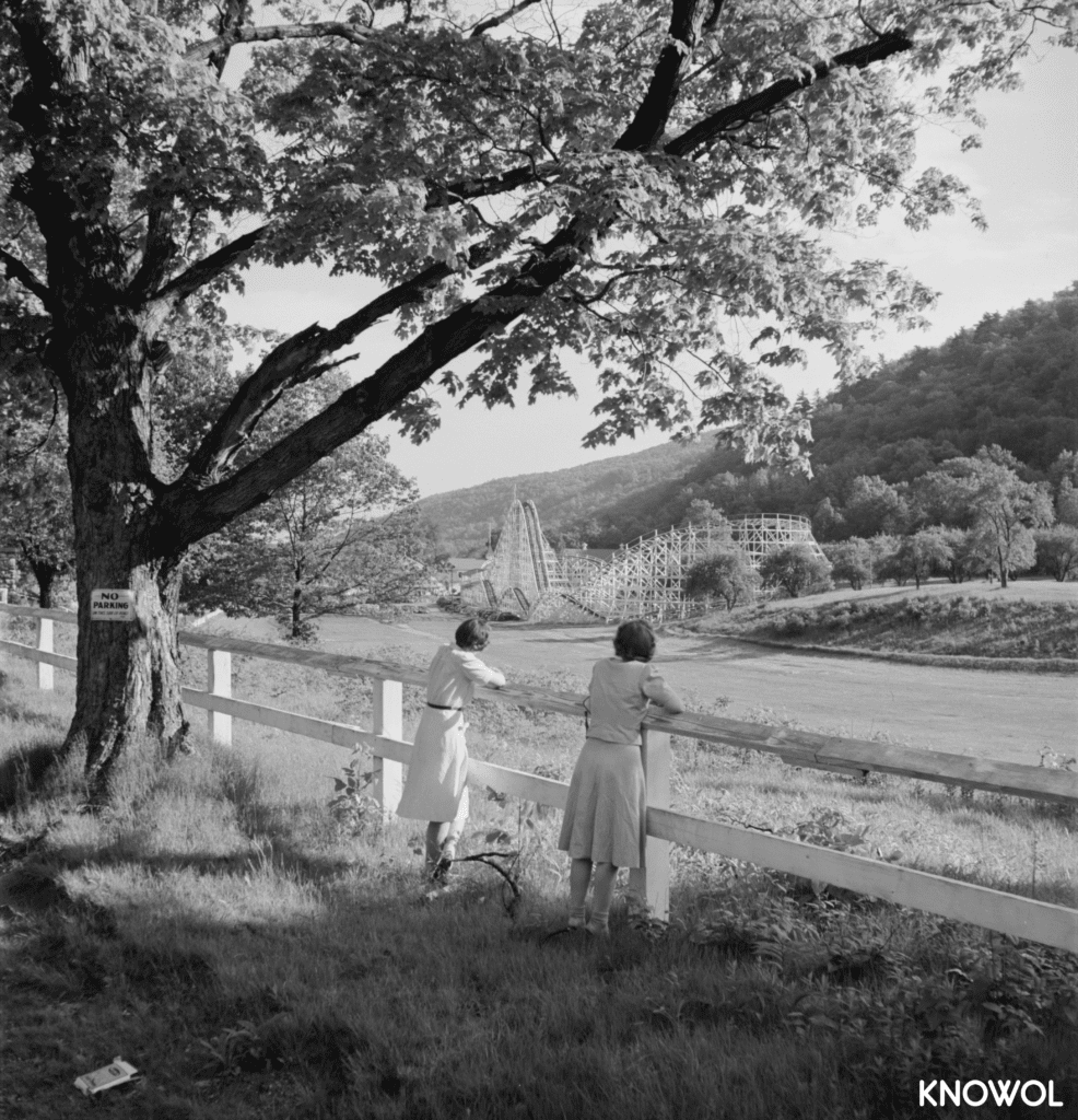 Two women looking over a fence at the Wildcat roller coaster.