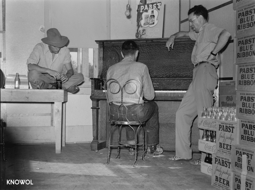 Three men harmonizing in the back room of a bar, surrounded by cases of Pabst Blue Ribbon.