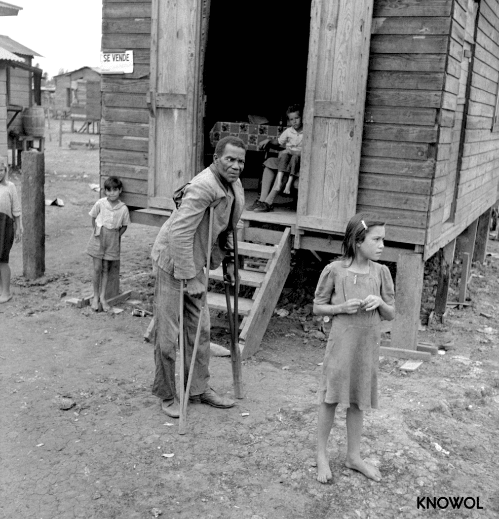 A disabled man walking around El Fangitto, "The Mud", on crutches.