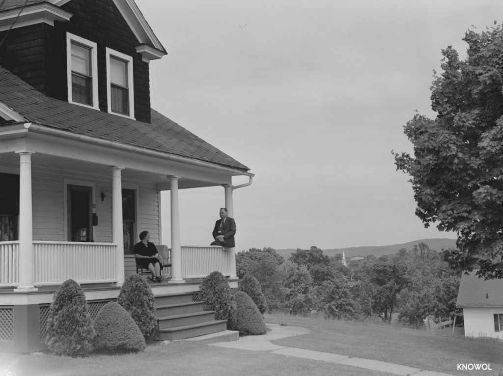 A couple sits on the porch of their home in Southington, CT.